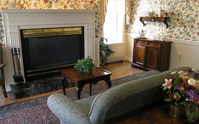 Cozy common area with a fireplace and floral decor