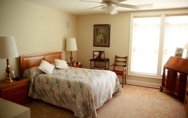 Cozy private resident room with a bed and furniture