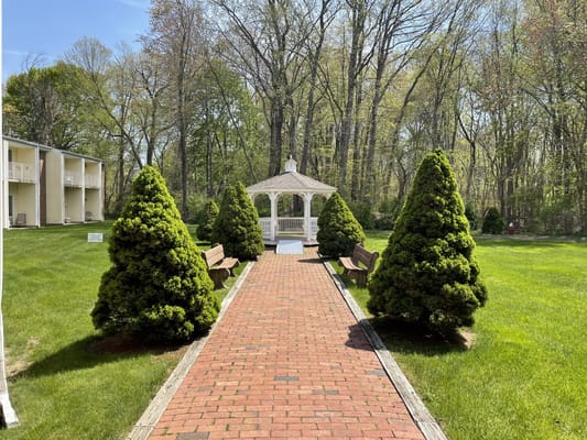 Pathway leading to a gazebo in a landscaped garden