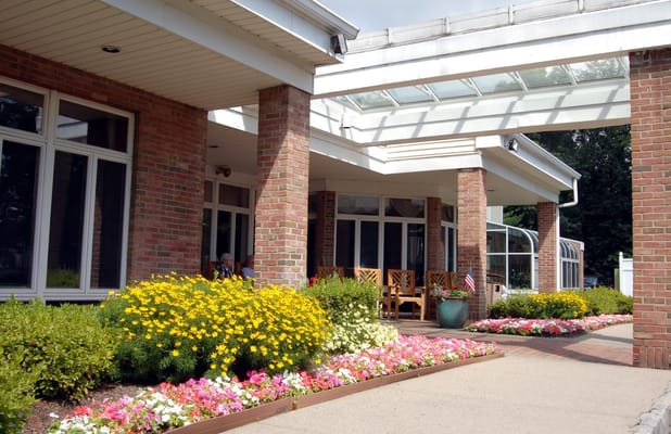 Exterior view of a facility entrance with flowers