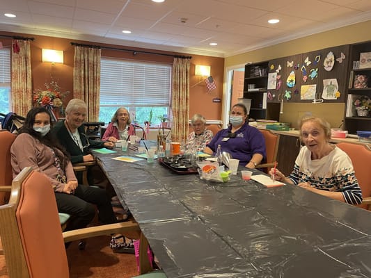 Residents engaging in an arts and crafts activity in a common area