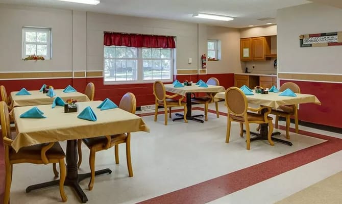 Dining area with set tables and blue napkins