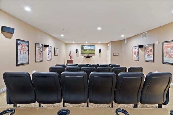 A home theater room with seating and a screen