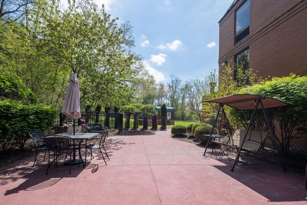 Outdoor seating area with swing and table