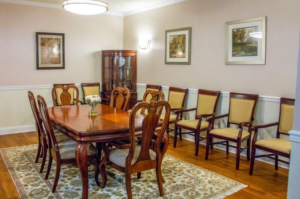 Interior dining room with a large wooden table and chairs