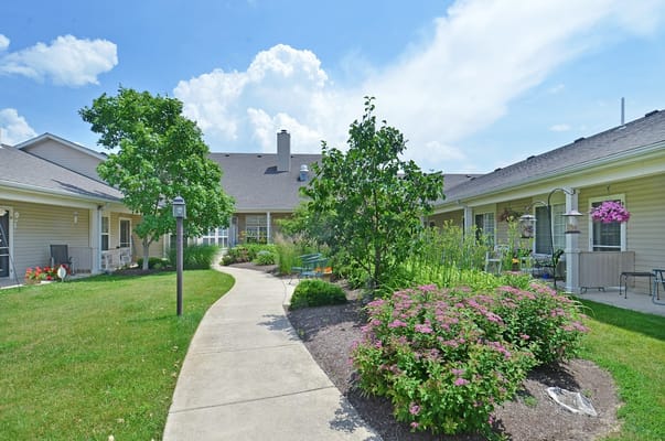 Pathway through a landscaped garden at Muncie Estates Senior Living