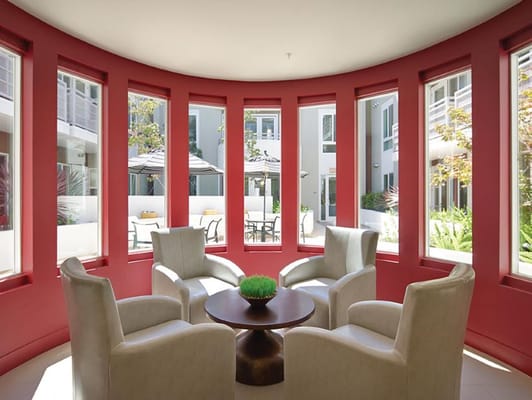 Bright common area with seating and large windows