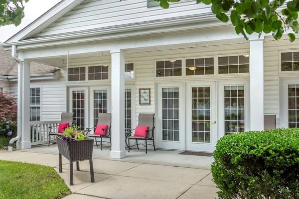 Porch with seating and potted plants at Navion of Greenville
