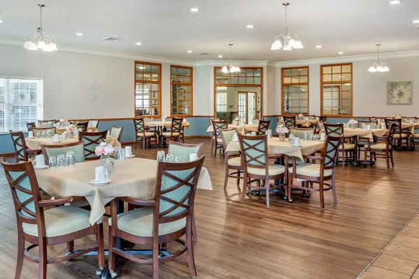 Spacious dining area with tables set for meals