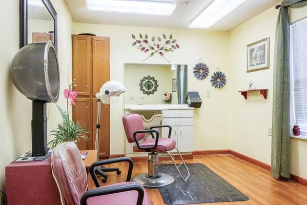 Interior view of the salon with styling chair and hairdryer.