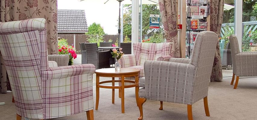 Lounge area with patterned armchairs and a small table