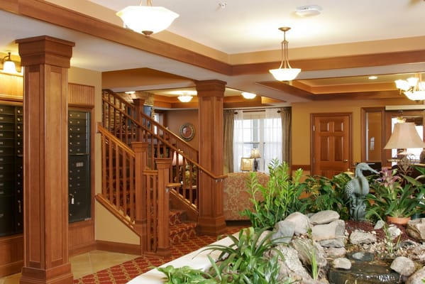 Inviting lobby with plants and a decorative fountain.