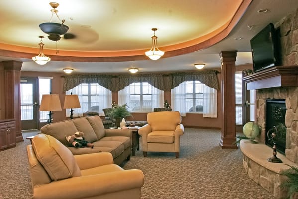 A spacious living room with comfortable seating and large windows.