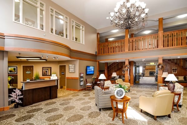 Interior view of a lobby area with seating and chandeliers