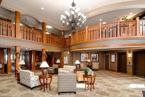 Common area with seating and chandelier in a senior living facility