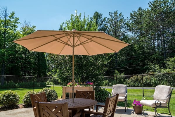 Outdoor patio area with seating and an umbrella