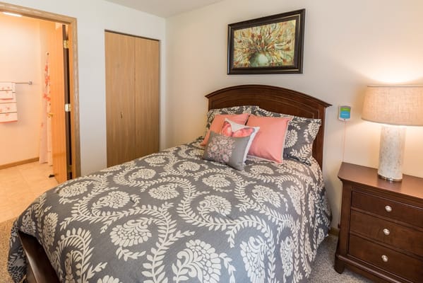 Cozy bedroom with floral bedding and bedside lamp