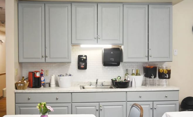 Kitchen area with cabinets and beverage dispensers
