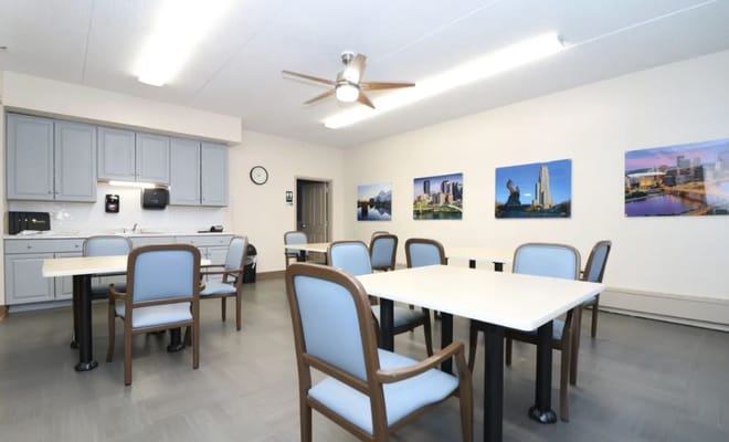 Bright, spacious common area with tables and chairs