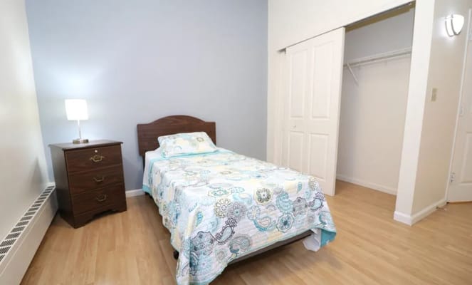 Private resident room with bed and dresser