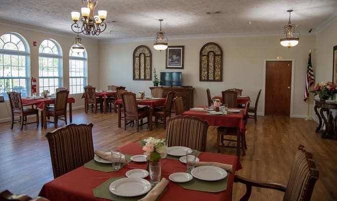Spacious dining room with wooden tables and chairs at NorthCliff