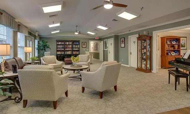 Cozy lounge area with seating and bookshelves.