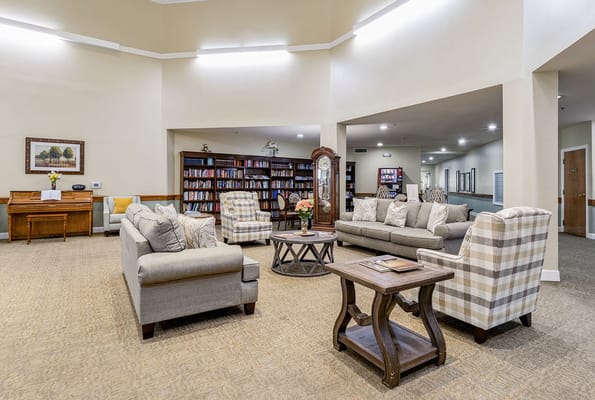 Comfortable seating arrangement in the common area with bookshelves in the background