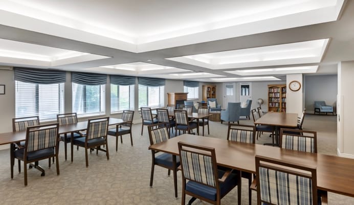 Bright and spacious common area with tables and seating.