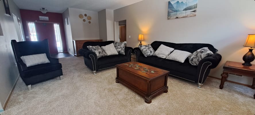 Cozy common area with black sofas and lamps