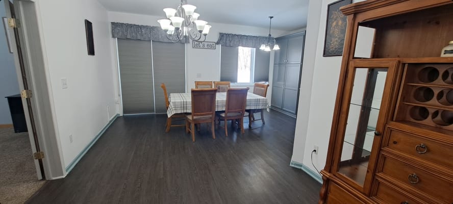 Bright dining room with a large table and chandelier