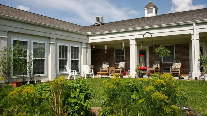 Outdoor patio area with seating and greenery