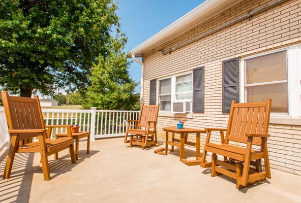 Patio with wooden chairs and a table