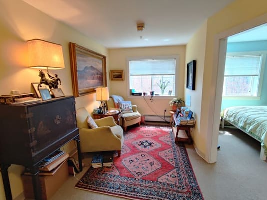 Cozy resident room with a vibrant rug and furniture