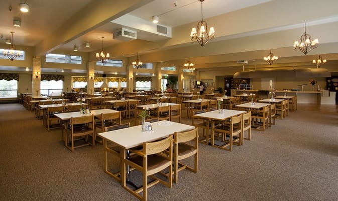 Spacious dining area with wooden tables and chairs