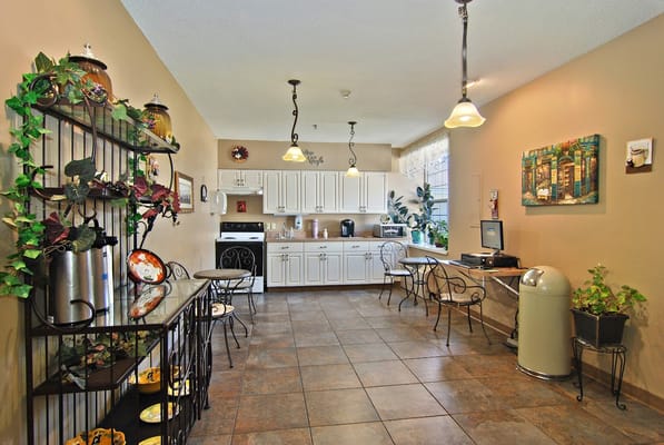 Bright kitchen space with dining tables and a computer station