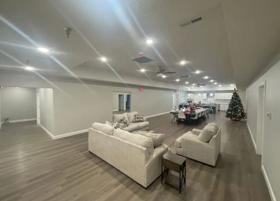 Interior view of a decorated common area with seating and dining table