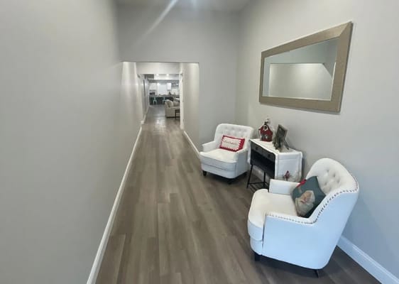 Interior hallway with white chairs and decor