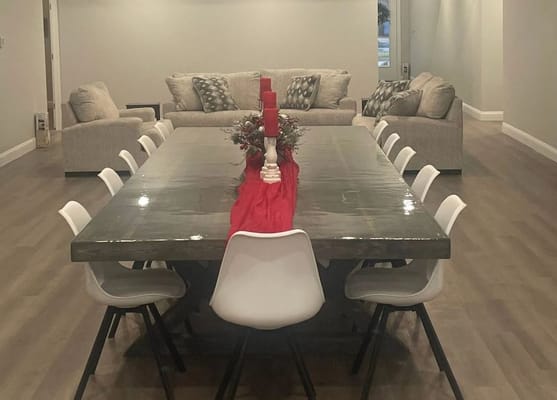 Dining room setup with a long table and seating