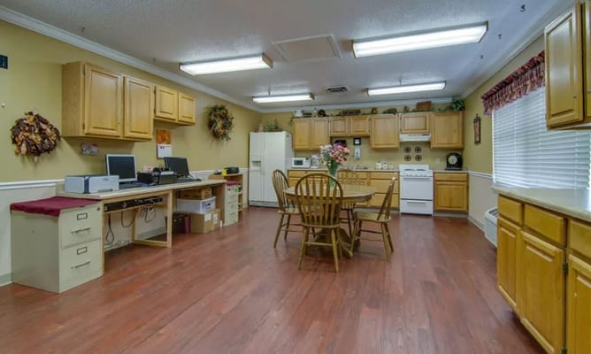 Kitchen area with wooden cabinets and dining table