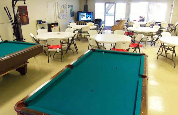 Interior common area with tables and a pool table