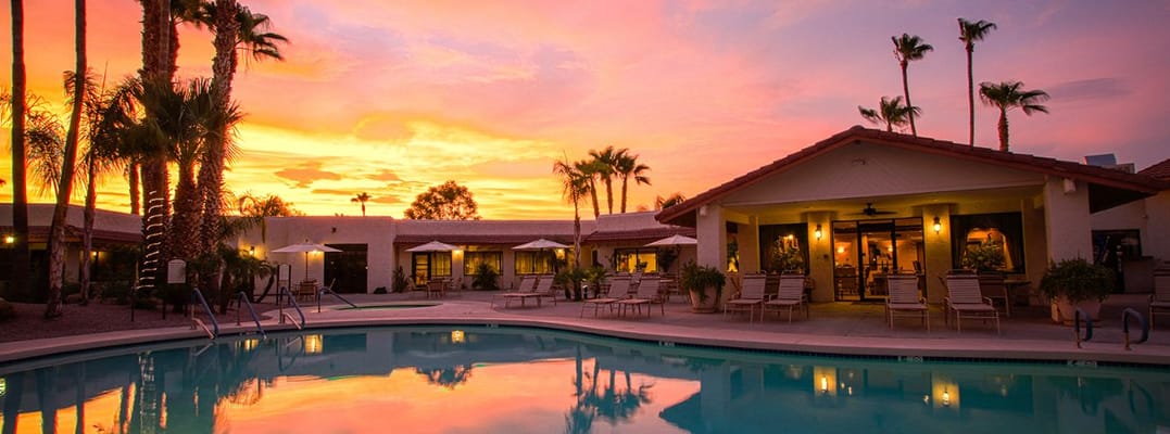 Beautiful sunset over the pool and building of community