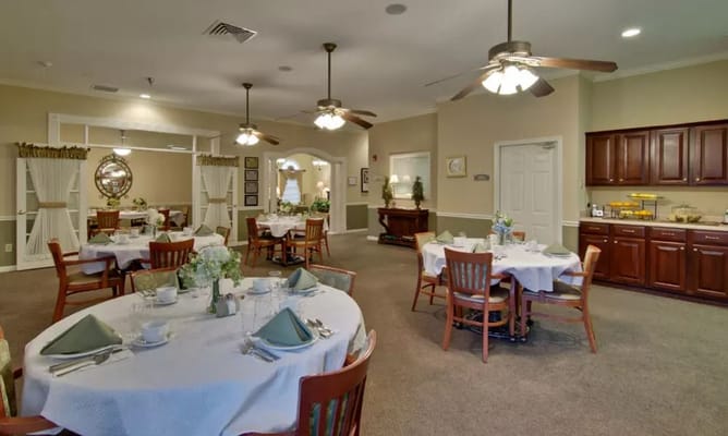 Cozy dining area with round tables set for meals.