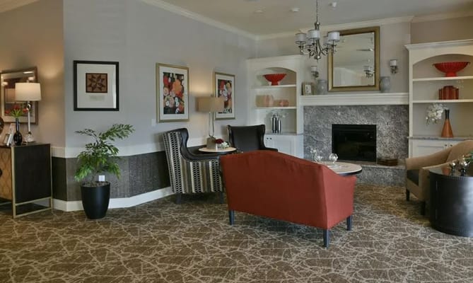 Living room with comfortable seating and decorative shelves.
