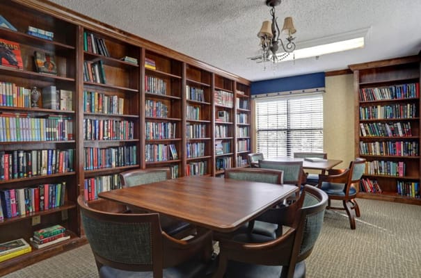 Interior view of a library with bookshelves and tables