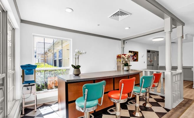 Bright common area with colorful seating and natural light