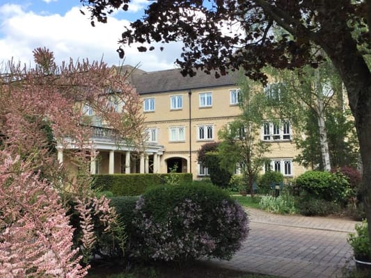 Exterior view of a nursing home surrounded by gardens