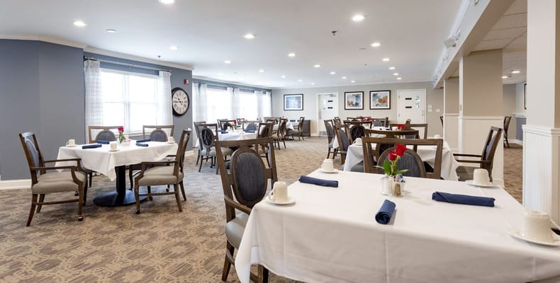 Dining area setup with elegant decor and flower centerpiece