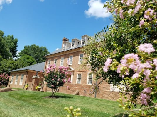 Exterior view of Petersburg Home for Ladies with flowering bushes