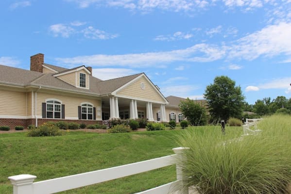 Exterior view of a senior living facility with landscaped grounds