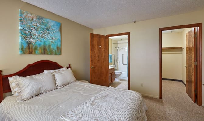 A well-furnished resident room with a bathroom